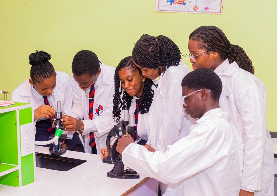 College students using microscopes in the science lab