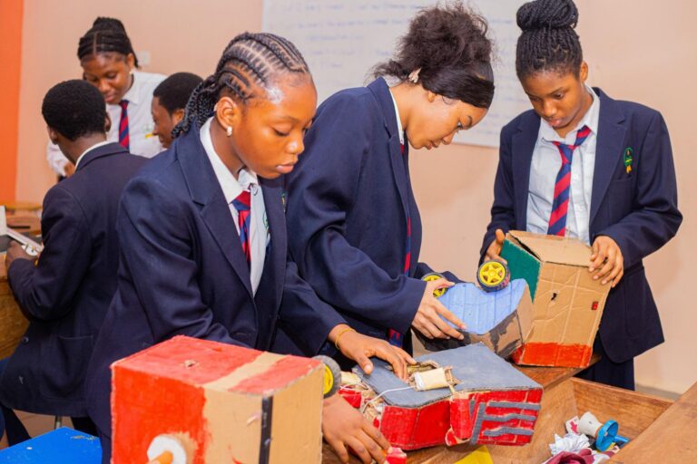 College students building craft and technology projects from recycled materials