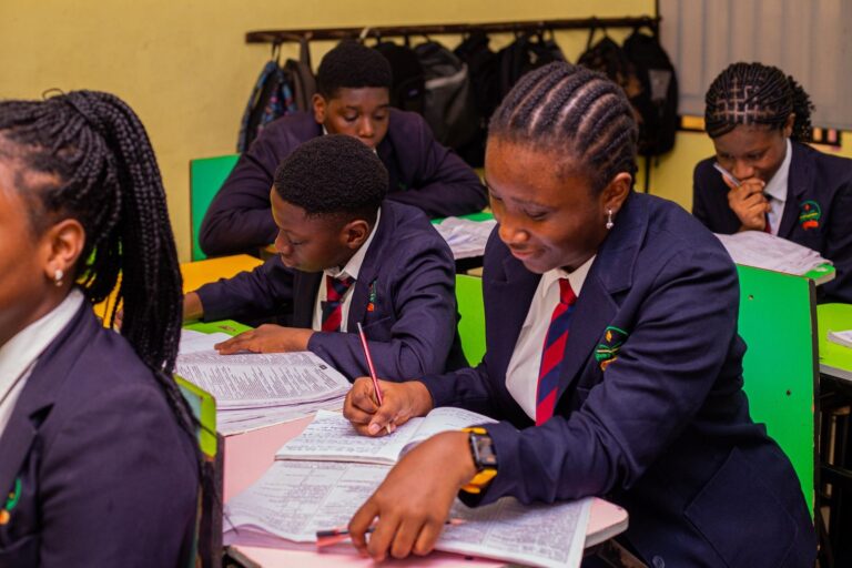College students writing and studying in class
