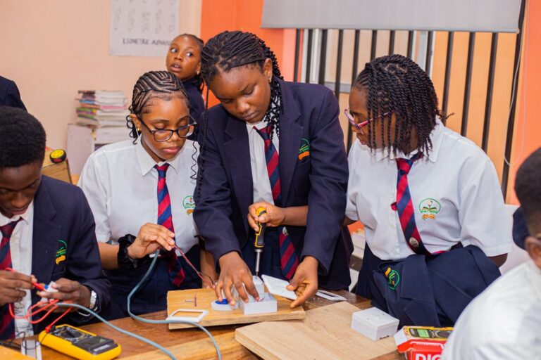 College students wiring electronic circuits with a multimeter