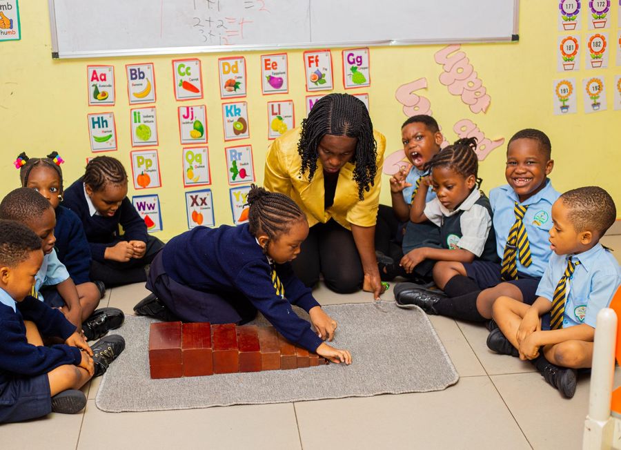 Nursery pupils and their teacher during a Montessori circle-time lesson